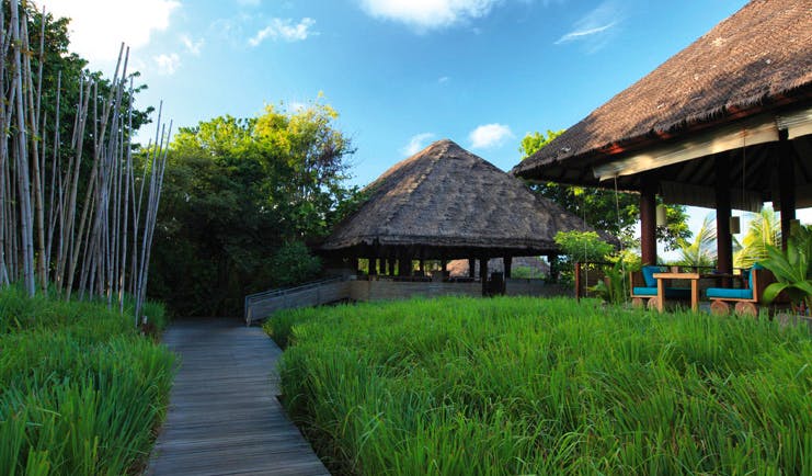 Six Senses Samui Thailand restaurant entrance path through gardens to dining pavilion