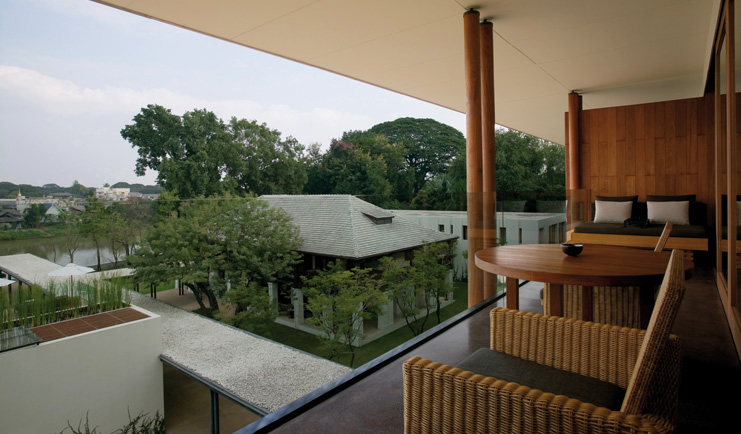 The Dhara Devi Thailand balcony wicker chairs sofa table river view