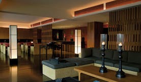 The Dhara Devi Thailand club lounge sofas armchairs candles modern minimalist decor