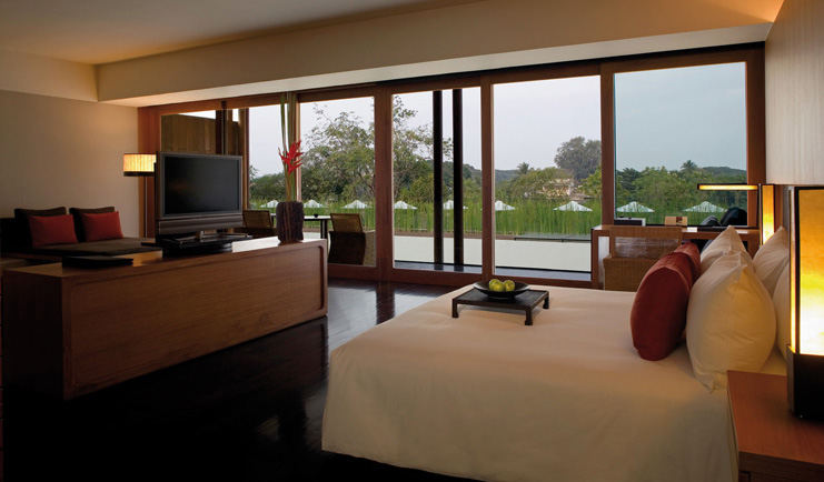 The Dhara Devi Thailand club suite bedroom sitting area panoramic window river view