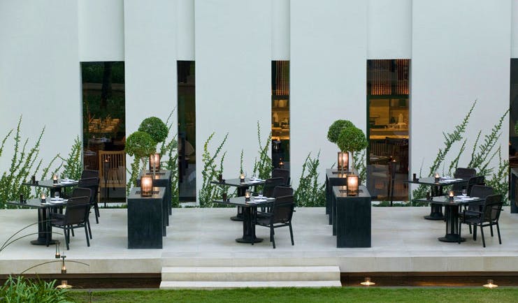 The Dhara Devi Thailand courtyard dining modern white building lawns