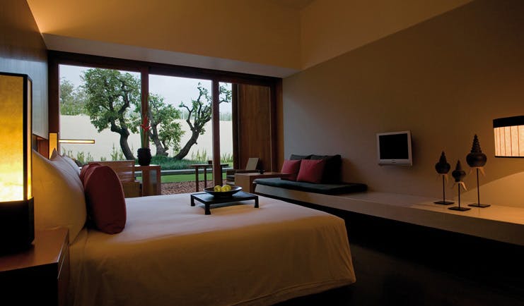 The Dhara Devi Thailand deluxe bedroom sitting area river and tree view