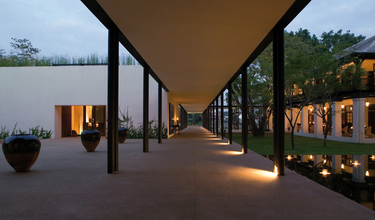 The Dhara Devi Thailand river walkway covered path pond floating candles evening 