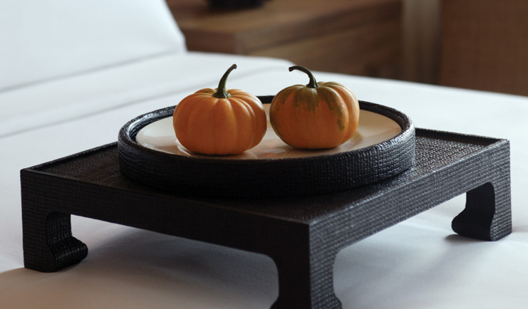 The Dhara Devi Thailand suite bedroom close up shots of miniature pumpkins on tray on bed
