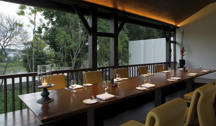The Dhara Devi Thailand upper restaurant terrace covered outdoor dining area long table river view