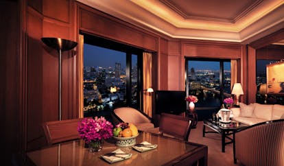 The Peninsula Bangkok Thailand grand deluxe suite lounge sitting area sofas desk river and city views