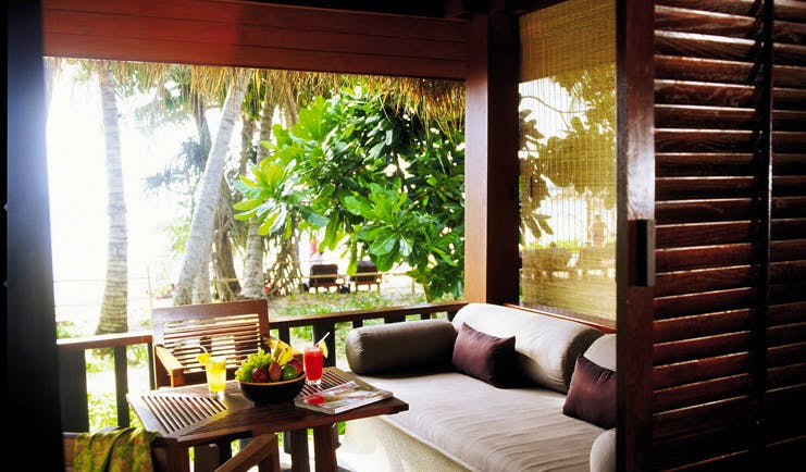 The Surin Phuket Thailand beach deluxe terrace sofa garden palm trees