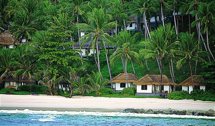 The Surin Phuket Thailand beach front suites palm trees view from the ocean