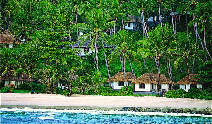 The Surin Phuket Thailand beach front suites palm trees view from the ocean