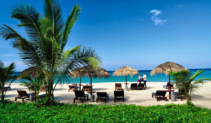 The Surin Phuket Thailand relaxation beach loungers thatched umbrellas