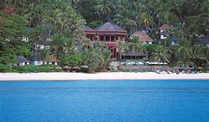 The Surin Phuket Thailand beach ocean palm trees hotel buildings