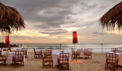 The Surin Phuket Thailand beachfront dining tables and chairs on the beach 