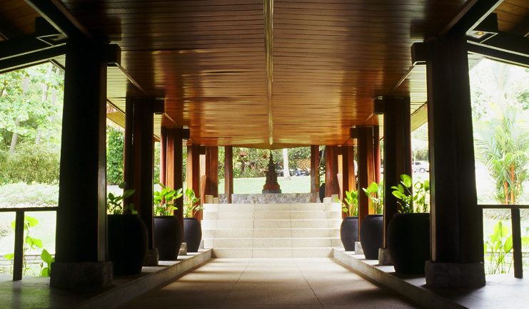 The Surin Phuket Thailand covered walkway trees greenery statue