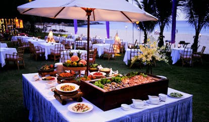The Surin Phuket Thailand outdoor buffet evening dining beach view