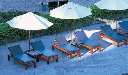 The Surin Phuket Thailand poolside sun loungers and umbrellas