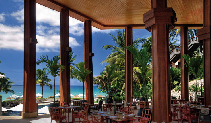 The Surin Phuket Thailand sunset restaurant covered open air dining room beach view 
