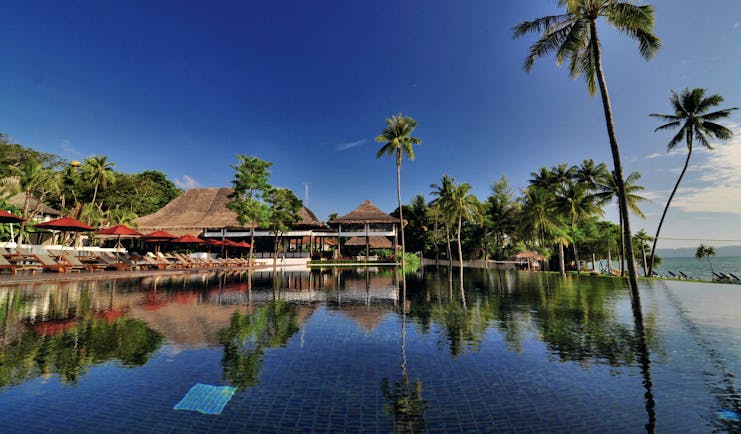 Vijitt Resort Thailand pool infinity pool sun loungers umbrellas overlooking beach