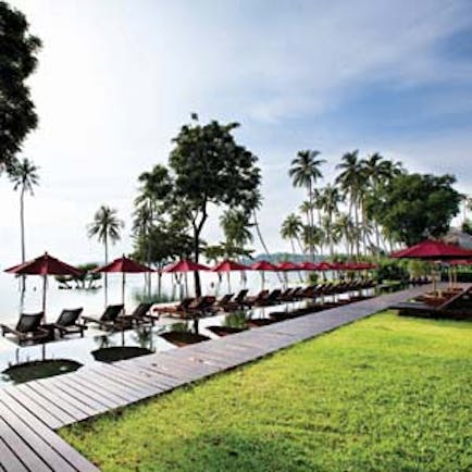 Vijitt Resort Thailand poolside sun loungers umbrellas lawns infinity pool overlooking sea