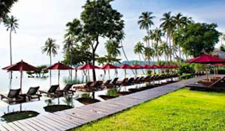 Vijitt Resort Thailand poolside sun loungers umbrellas lawns infinity pool overlooking sea