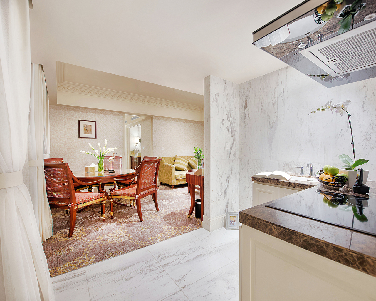 Apricot Hotel dining room and kitchenette, elegant decor, dining table, chairs, sofa