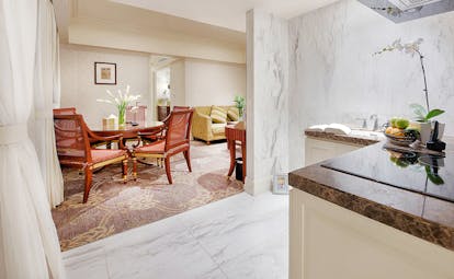 Apricot Hotel dining room and kitchenette, elegant decor, dining table, chairs, sofa