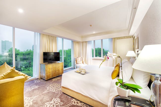 Apricot Hotel masterpiece suite bedroom, double bed, television, elegant decor, large windows with city views