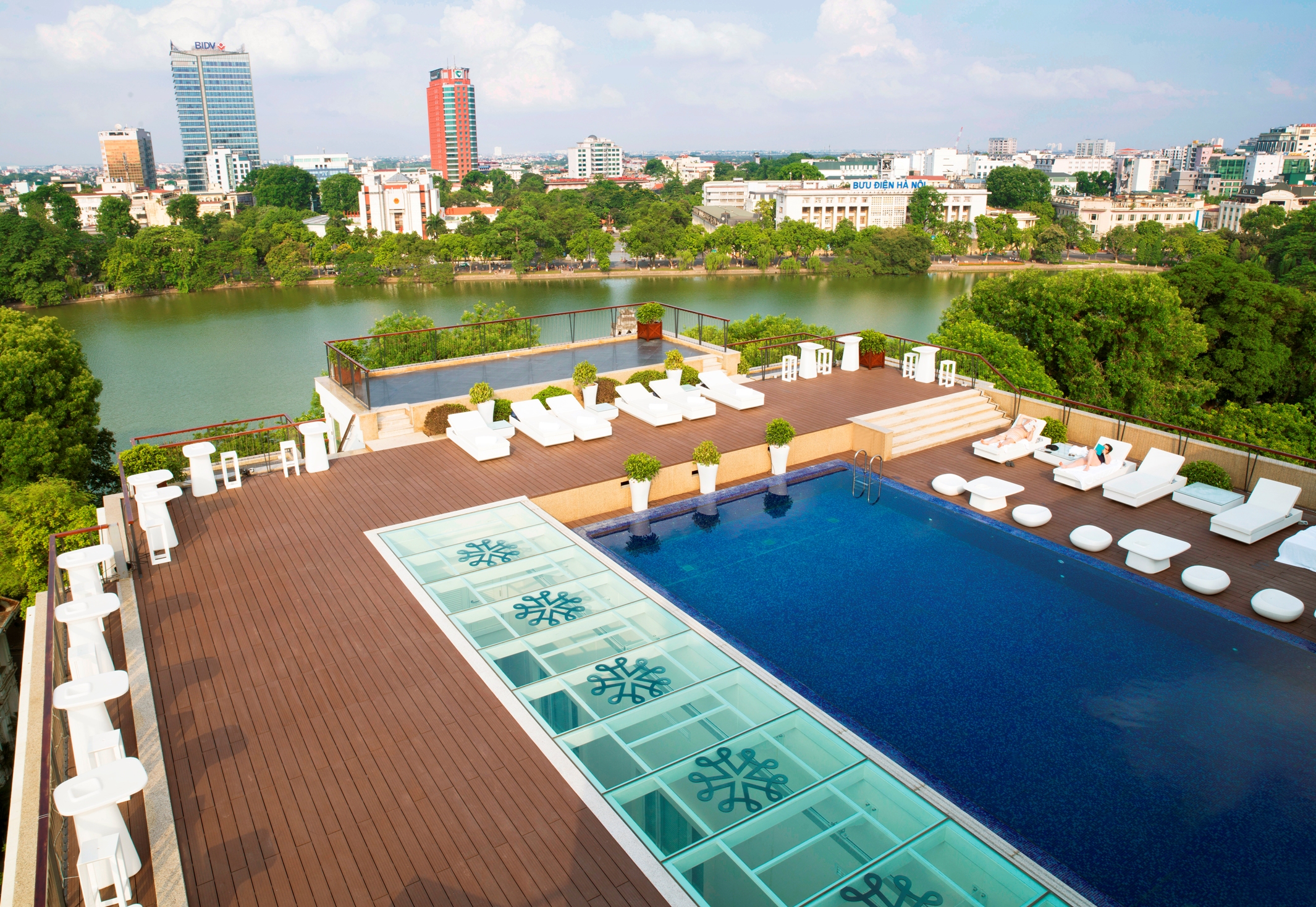 Apricot Hotel rooftop pool, sun loungers, view over river and city