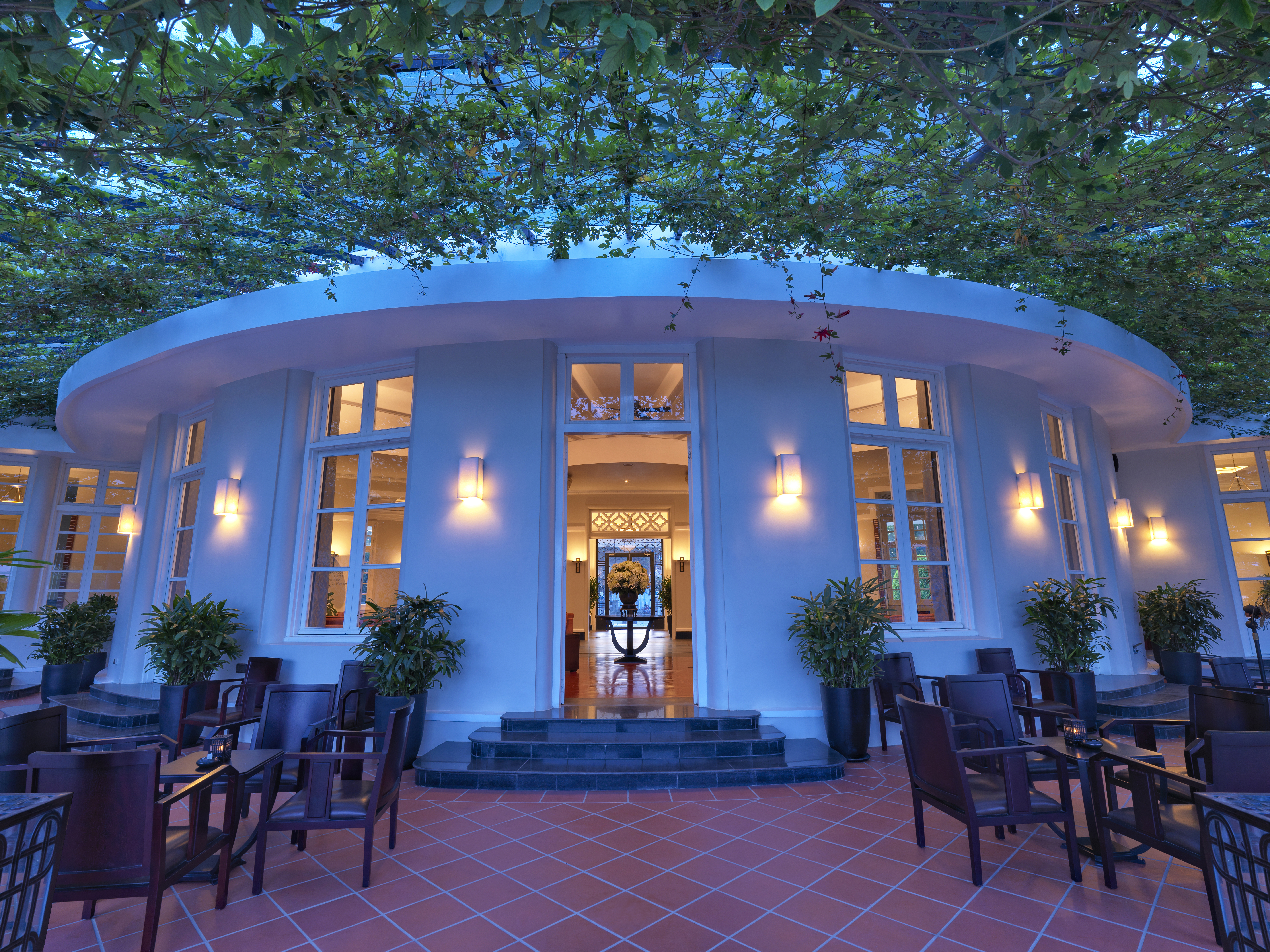 Azerai La Residence bar terrace, seating area under canopy of vines, tables and chairs