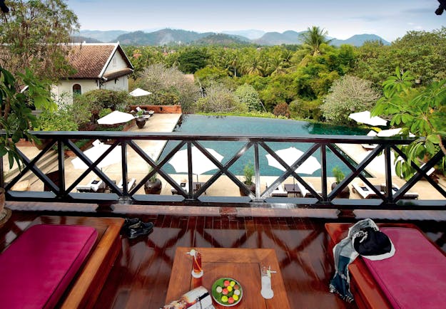 Belmond La Residence Phou Vao suite balcony, sun loungers, pool and mountain view