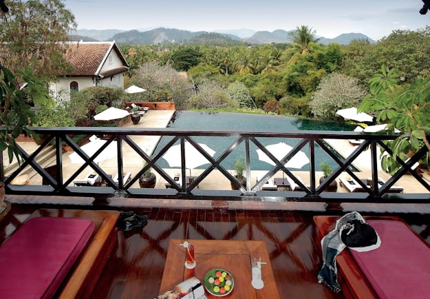 Belmond La Residence Phou Vao suite balcony, sun loungers, pool and mountain view
