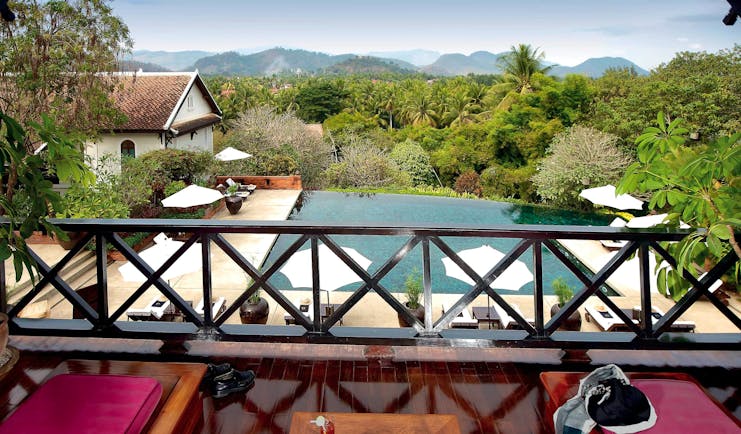 Belmond La Residence Phou Vao suite balcony, sun loungers, pool and mountain view