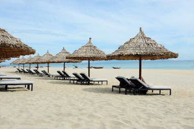 Boutique Hoi An beach, sandy beach, blue sea, sun loungers and umbrellas