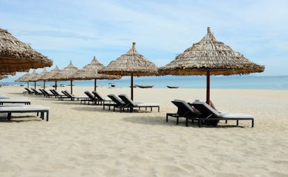 Boutique Hoi An beach, sandy beach, blue sea, sun loungers and umbrellas