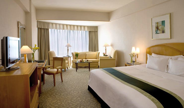 Caravelle Hotel Vietnam premium deluxe bedroom with lounge area