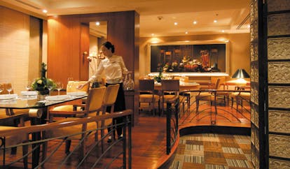 Caravelle Hotel Vietnam Reflections restaurant dining room waitress setting table