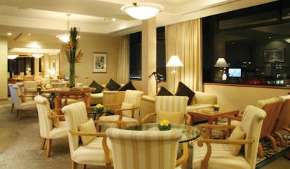 Caravelle Hotel Vietnam signature lounge seating area armchairs tables and sofas city view