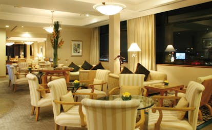 Caravelle Hotel Vietnam signature lounge seating area armchairs tables and sofas city view