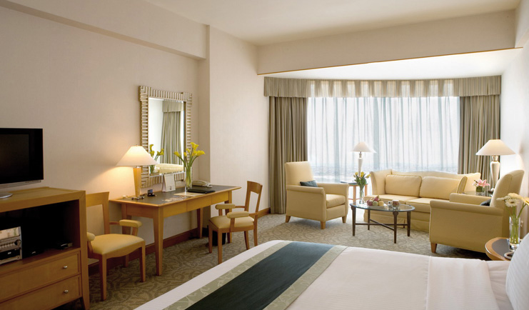 Caravelle Hotel Vietnam premium deluxe bedroom writing desk seating area with sofa