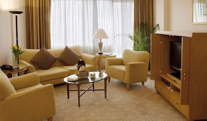 Caravelle Hotel Vietnam signature suite lounge sofas armchairs and television