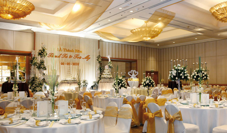 Caravelle Hotel Vietnam wedding reception room covered chairs floral arrangements