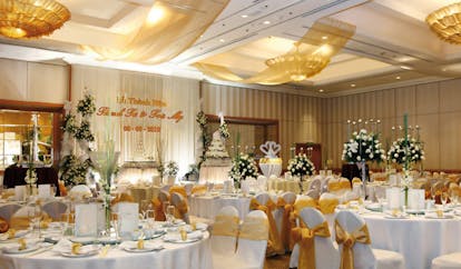 Caravelle Hotel Vietnam wedding reception room covered chairs floral arrangements