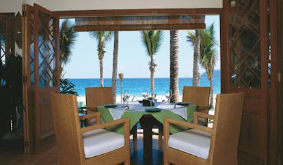 Evason Ana Mandara Resort Vietnam beach restaurant dining area with beach view palm trees
