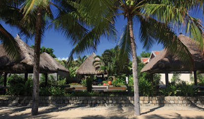 Evason Ana Mandara Resort Vietnam outdoor spa wooden thatched huts palm trees