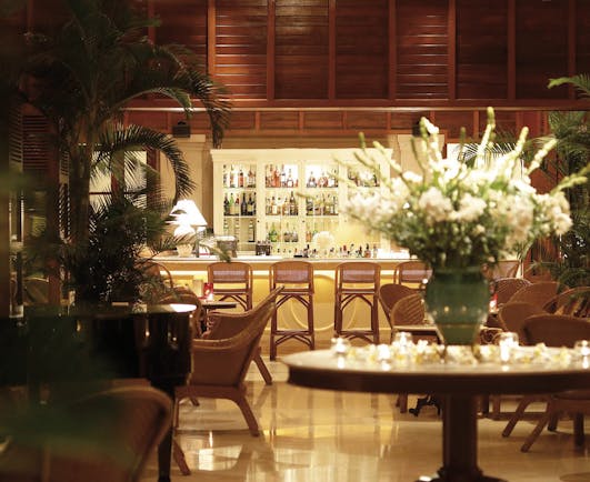Furama Resort Vietnam bar indoor seating area authentic décor fresh flowers