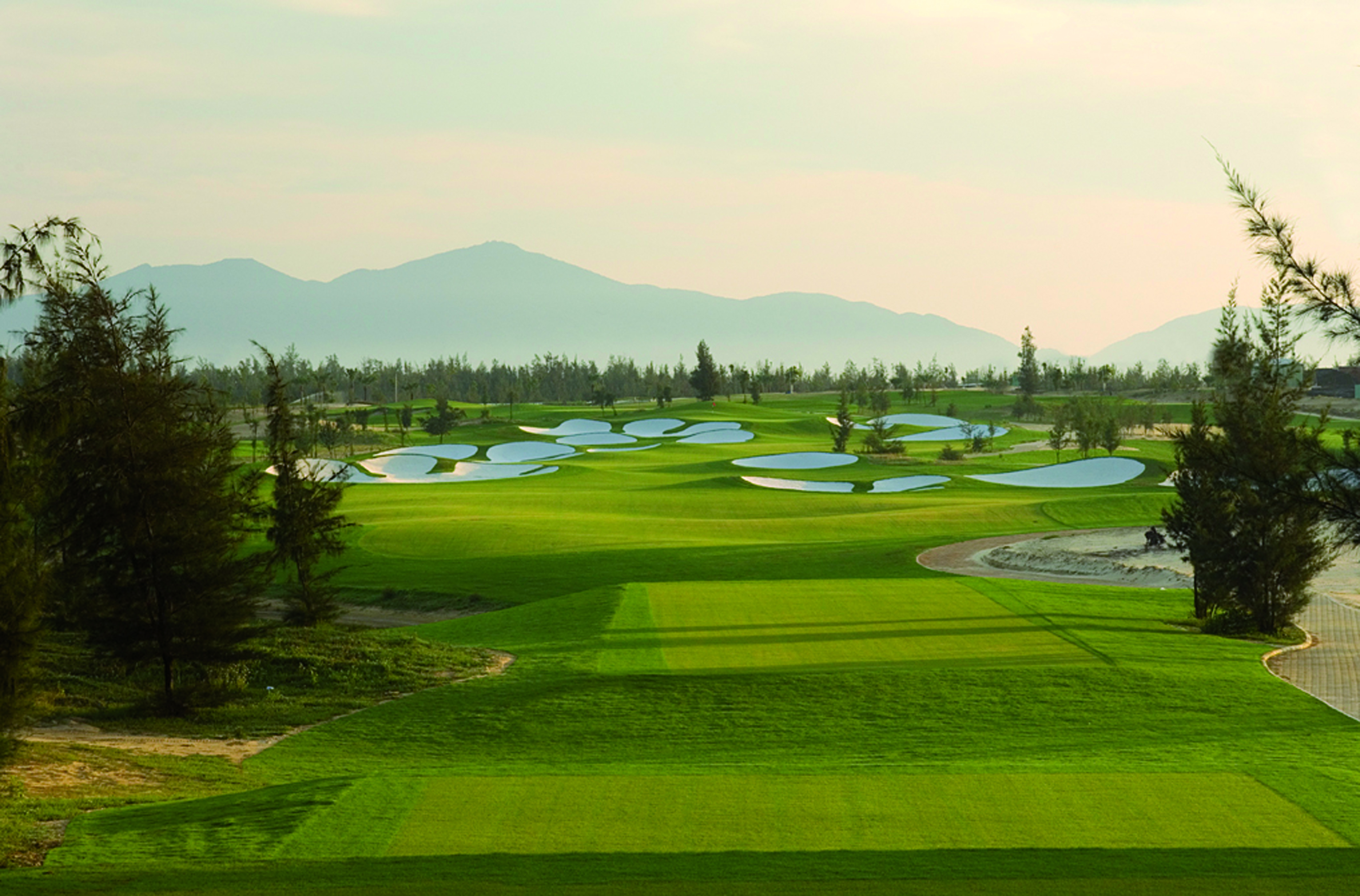 Furama Resort Vietnam golf course trees mountains in distance