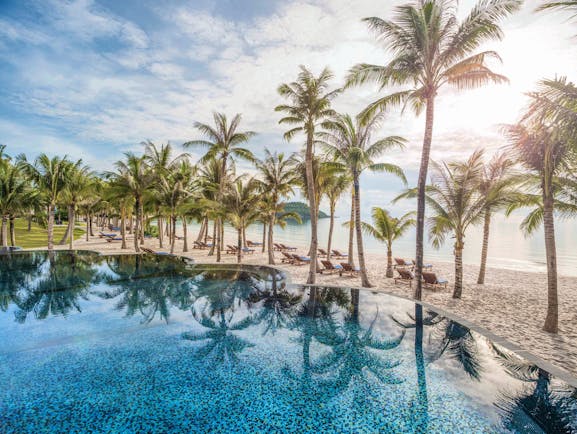 JW Marriott Phu Quoc Vietnam pool overlooking beach sand sea palm trees