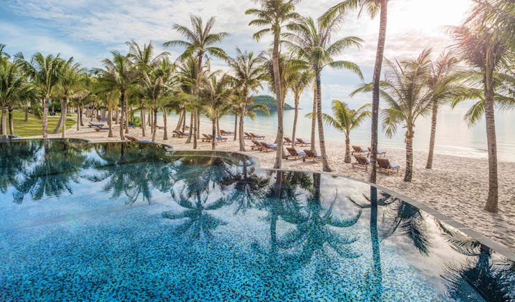 JW Marriott Phu Quoc Vietnam pool overlooking beach sand sea palm trees