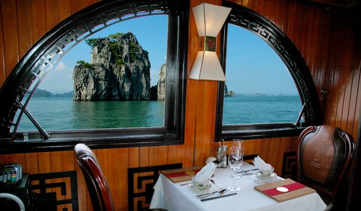 L'Amour Junk dining room, table set for two, window with view out onto bay