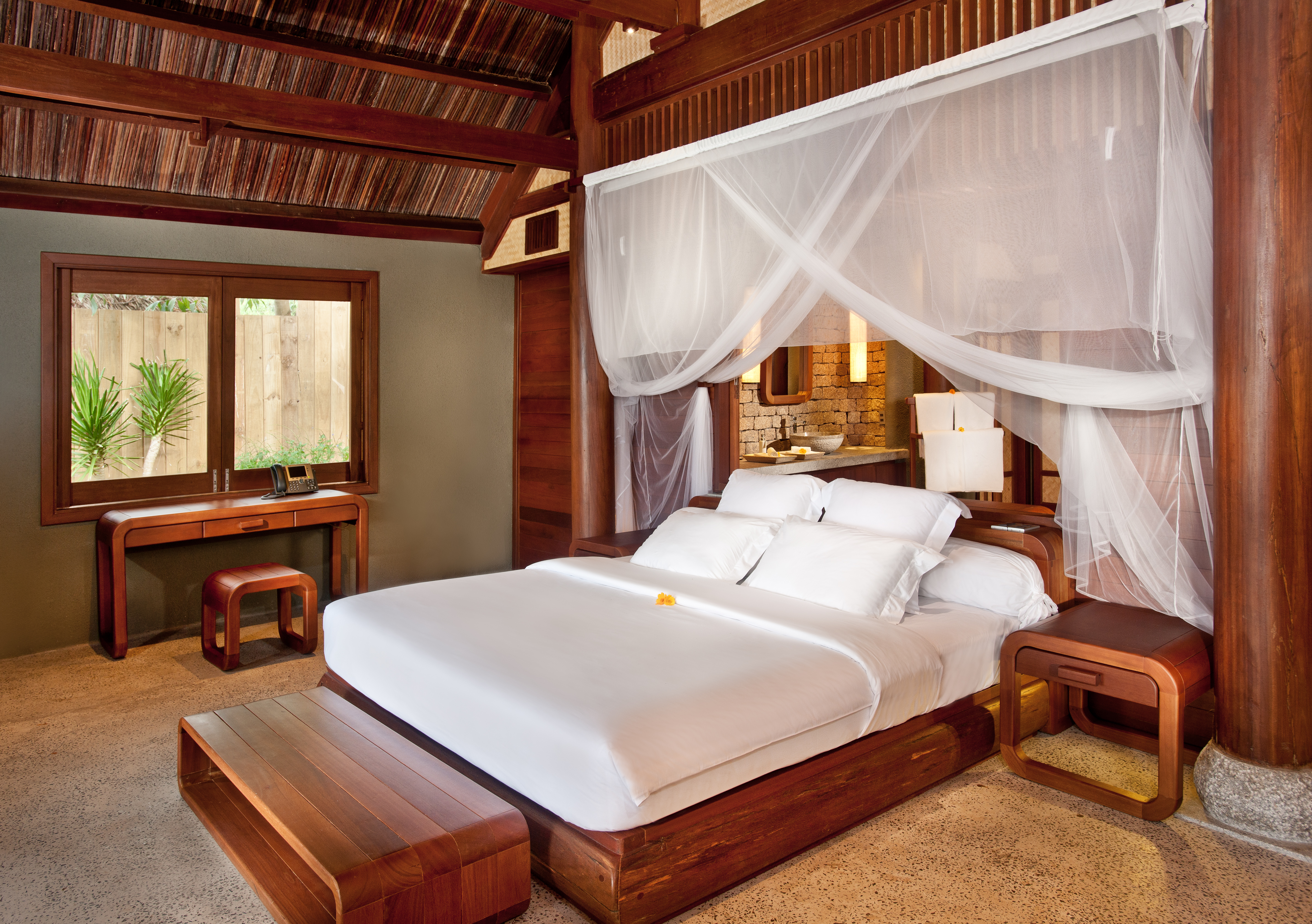 L'Ayla Ninh Van Bay lagoon villa bedroom, double bed with canopy, wooden panelling and decor