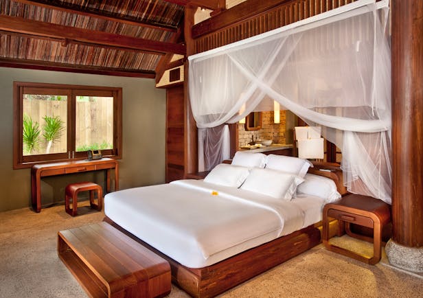 L'Ayla Ninh Van Bay lagoon villa bedroom, double bed with canopy, wooden panelling and decor